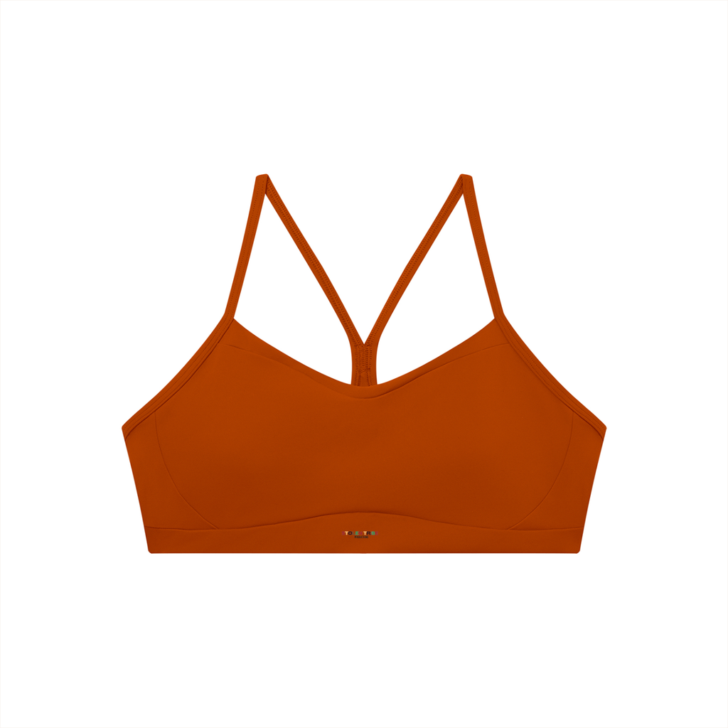 Orange bikini top with thin straps on a white background
