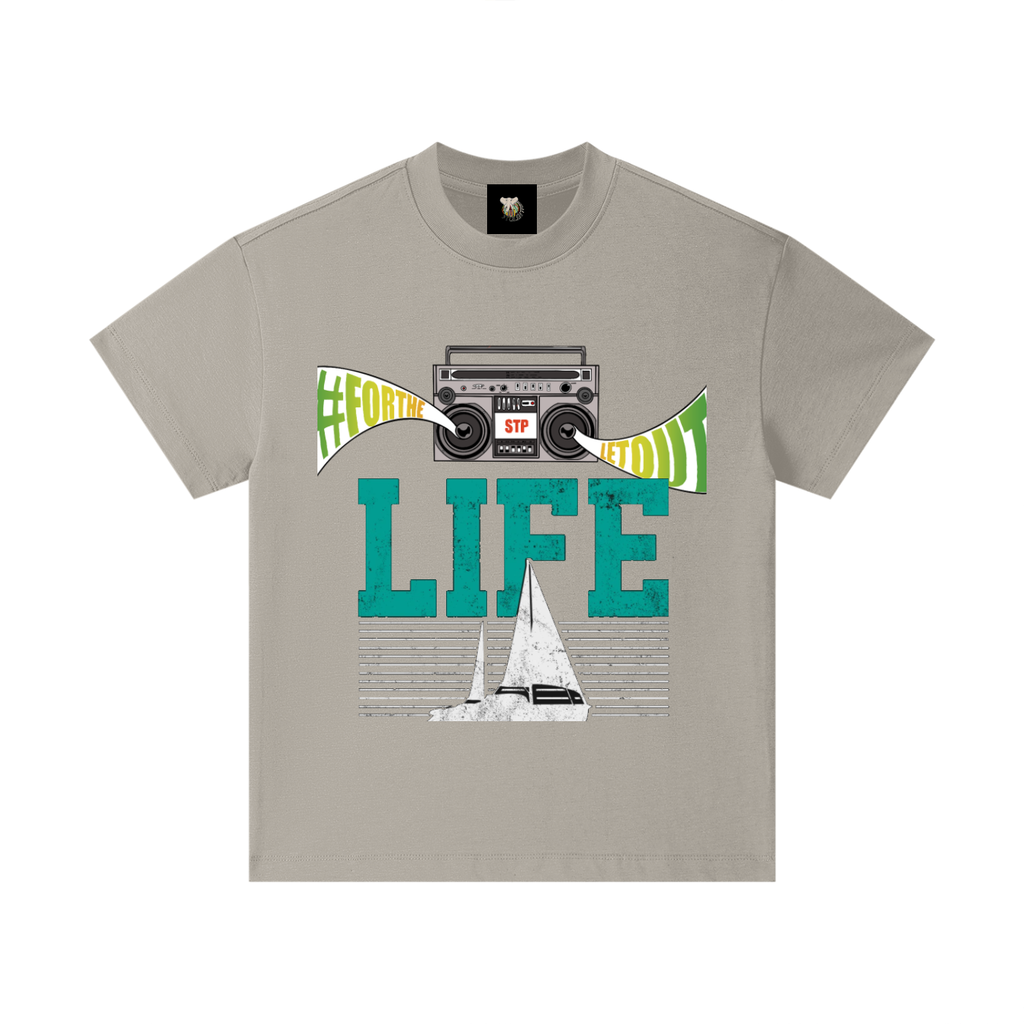 Beige t-shirt with graphic design featuring a sailboat, cassette player, and text on a white background