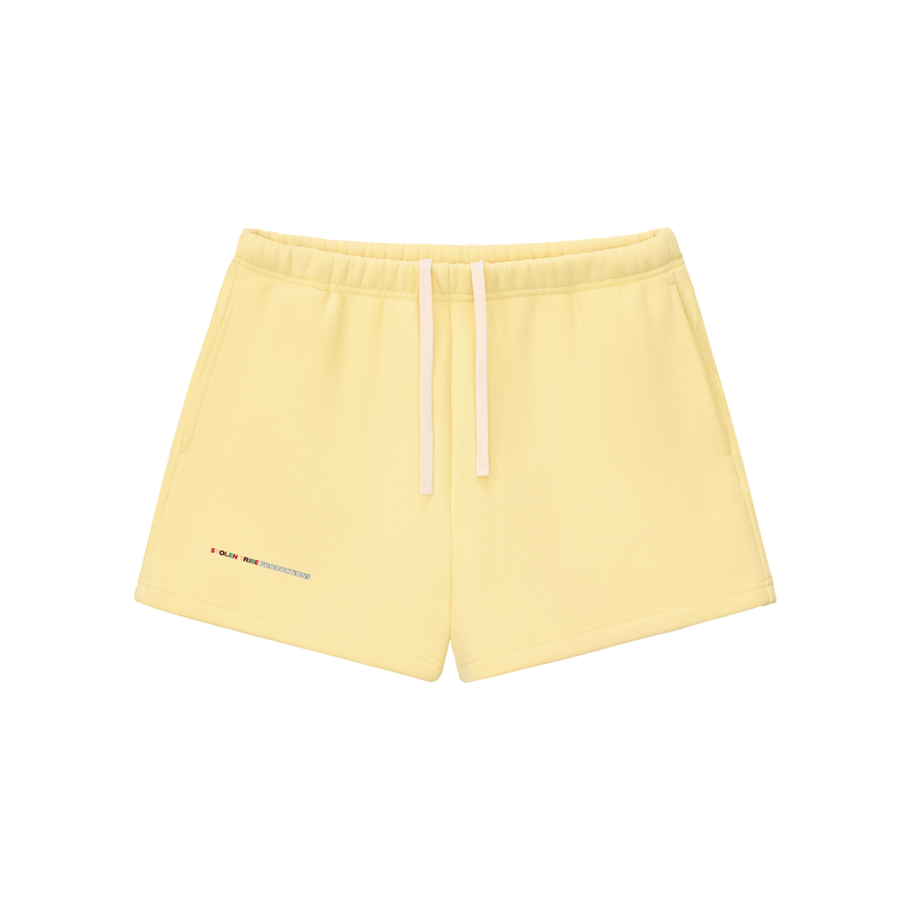 Yellow shorts with a brand logo on a white background