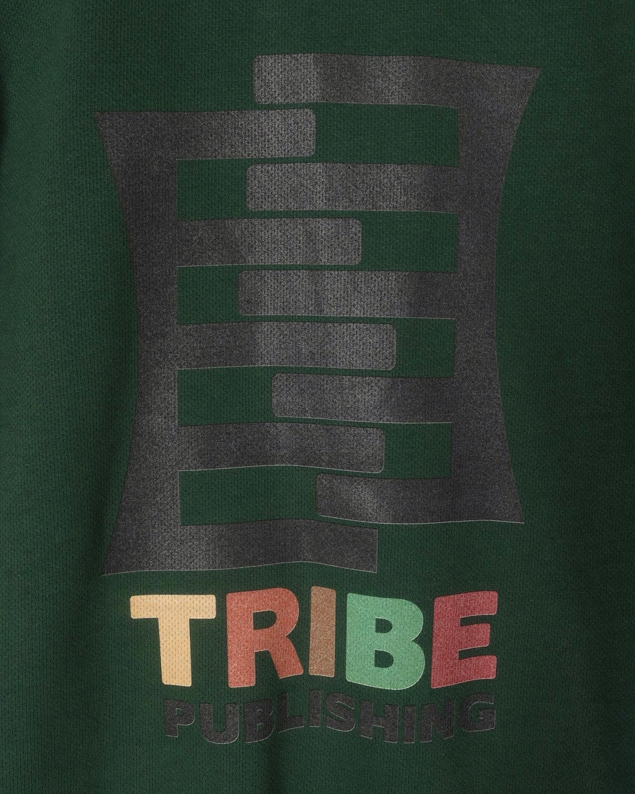 Green track jacket with 'TRIBE' logo and text on a dark green background