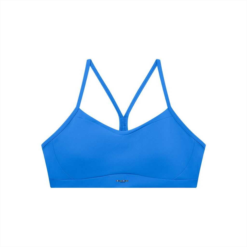 Blue sports bra with thin straps on a white background