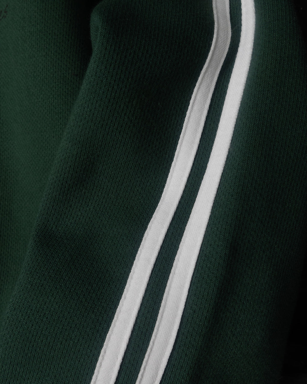Dark green fabric with a white stripe running vertically
