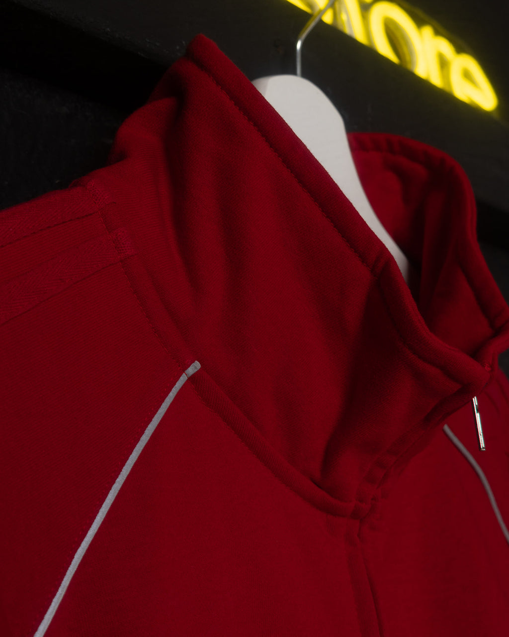 Red hoodie on a hanger with a blurred background
