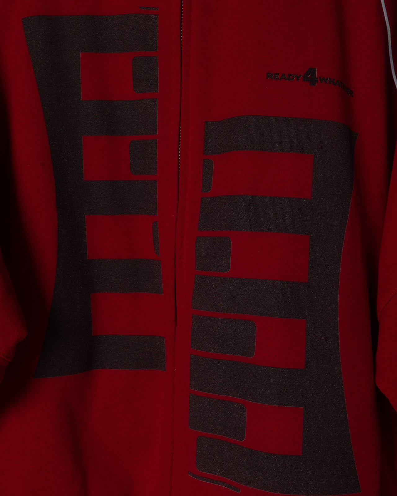 Red jacket with black geometric pattern and brand logo on a red background