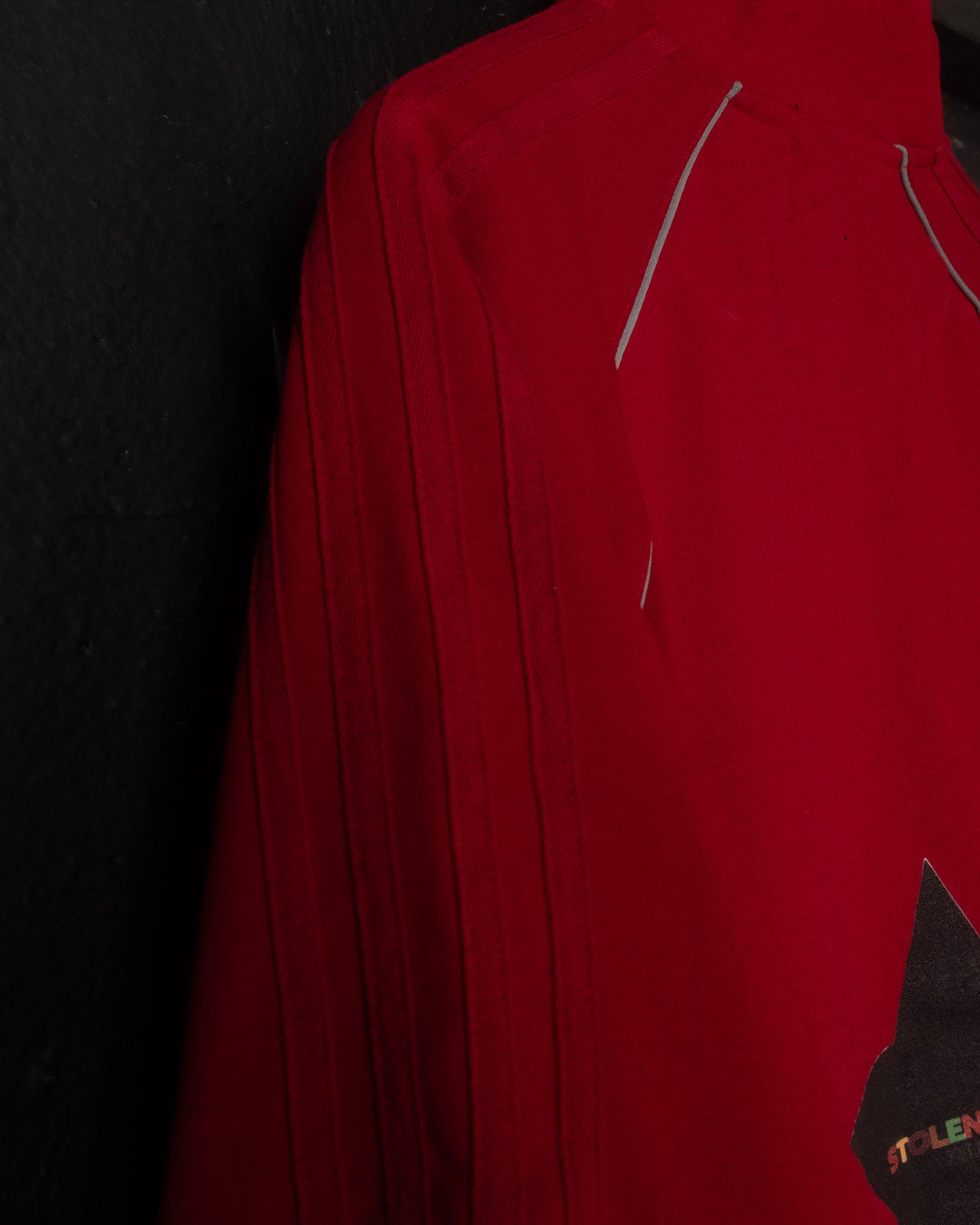 Red jacket with a brand logo on a black background