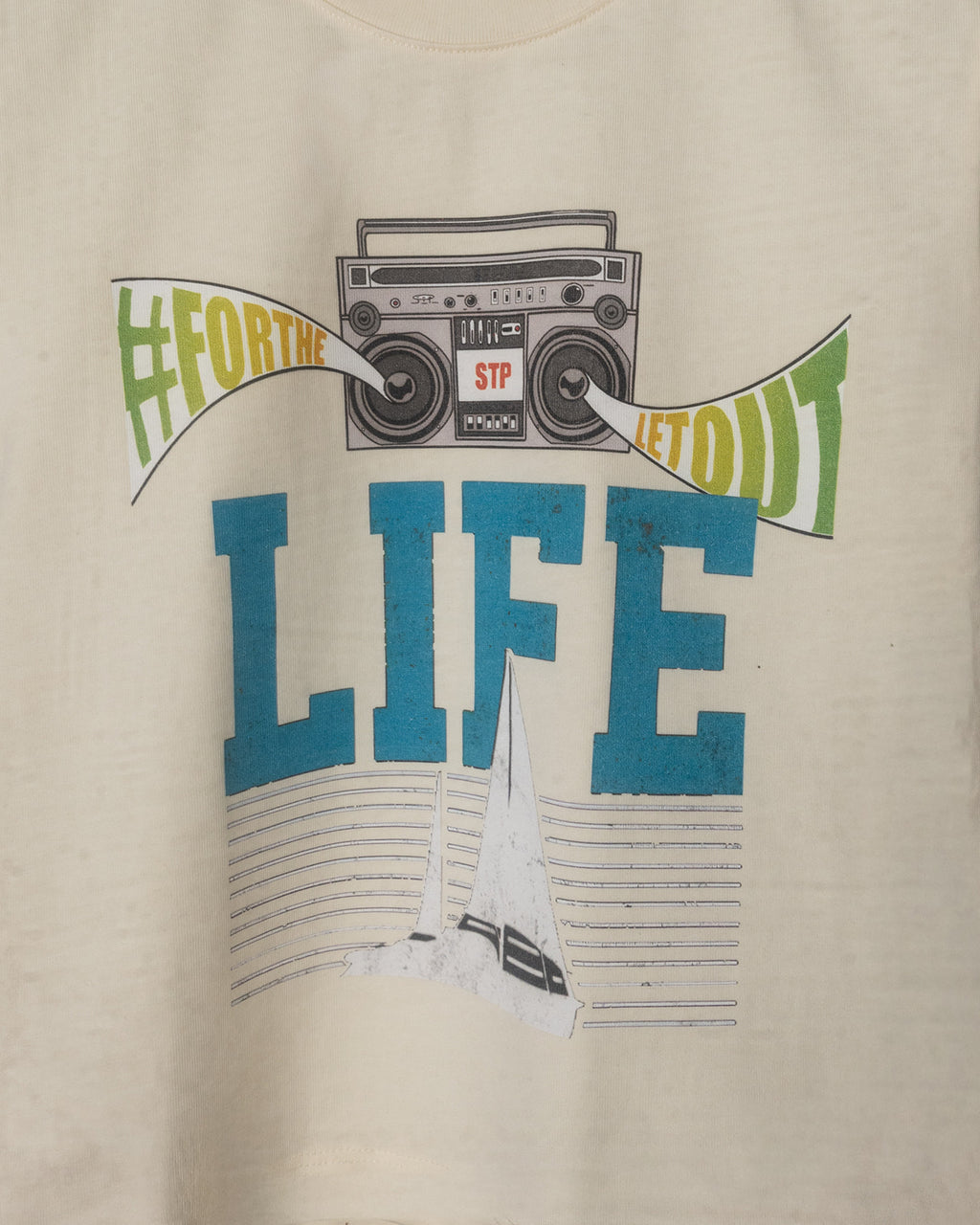 Beige t-shirt with graphic design featuring a boombox and text on a beige background