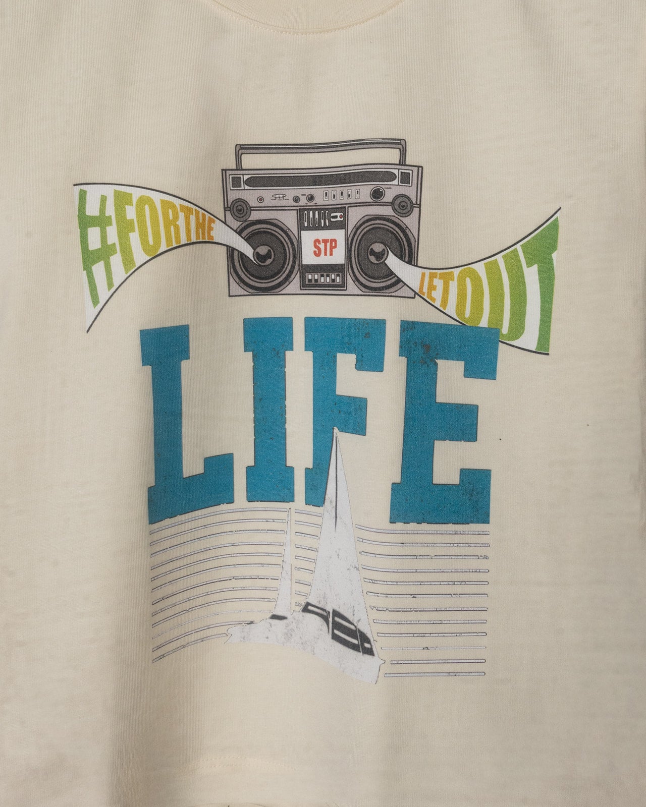 Beige t-shirt with graphic design featuring a boombox and text on a beige background