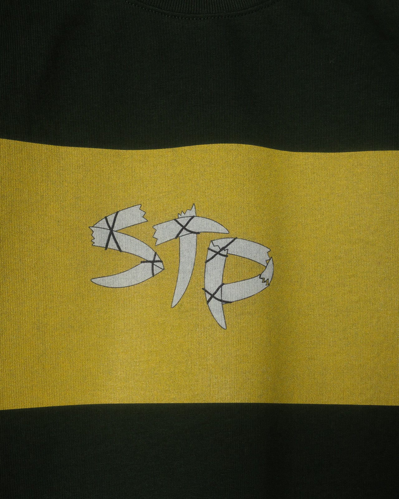 Green and yellow striped shirt with a STP logo on a yellow section