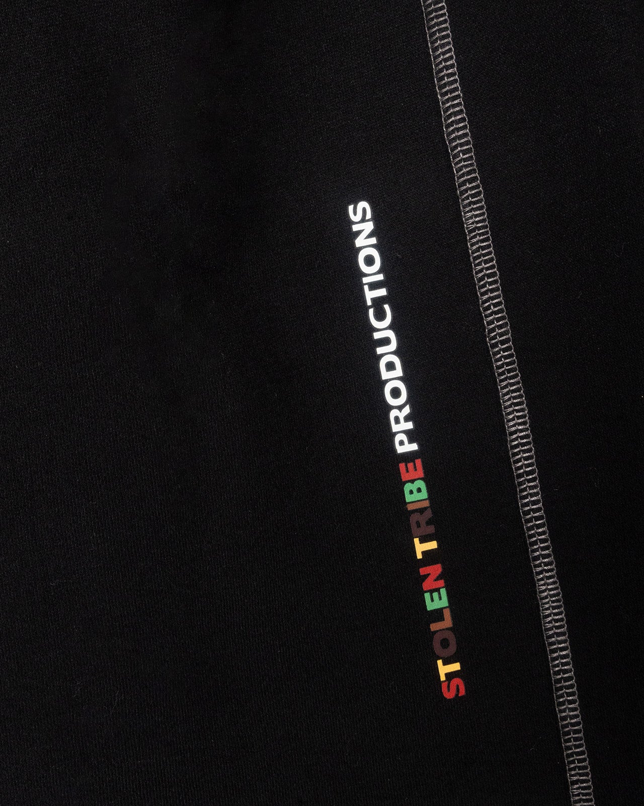 Black Sweatpants with 'Stolen Tribe Productions' logo on a black background