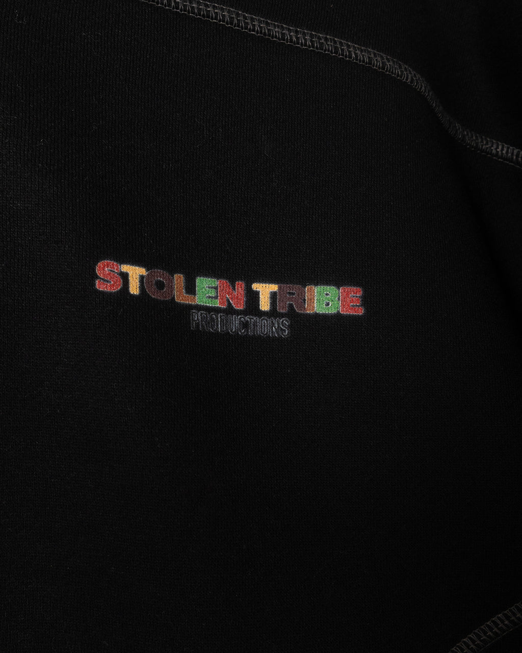Embroidered 'Stolen Tribe Productions' logo on a black background