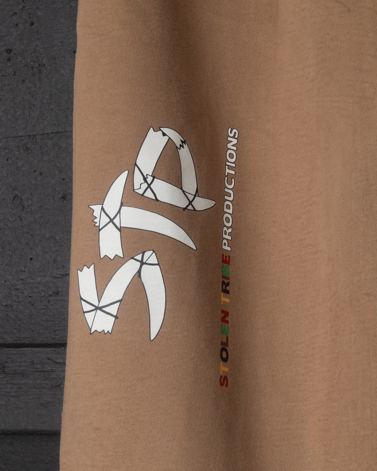Brown sweatpants with a logo and text on a plain background