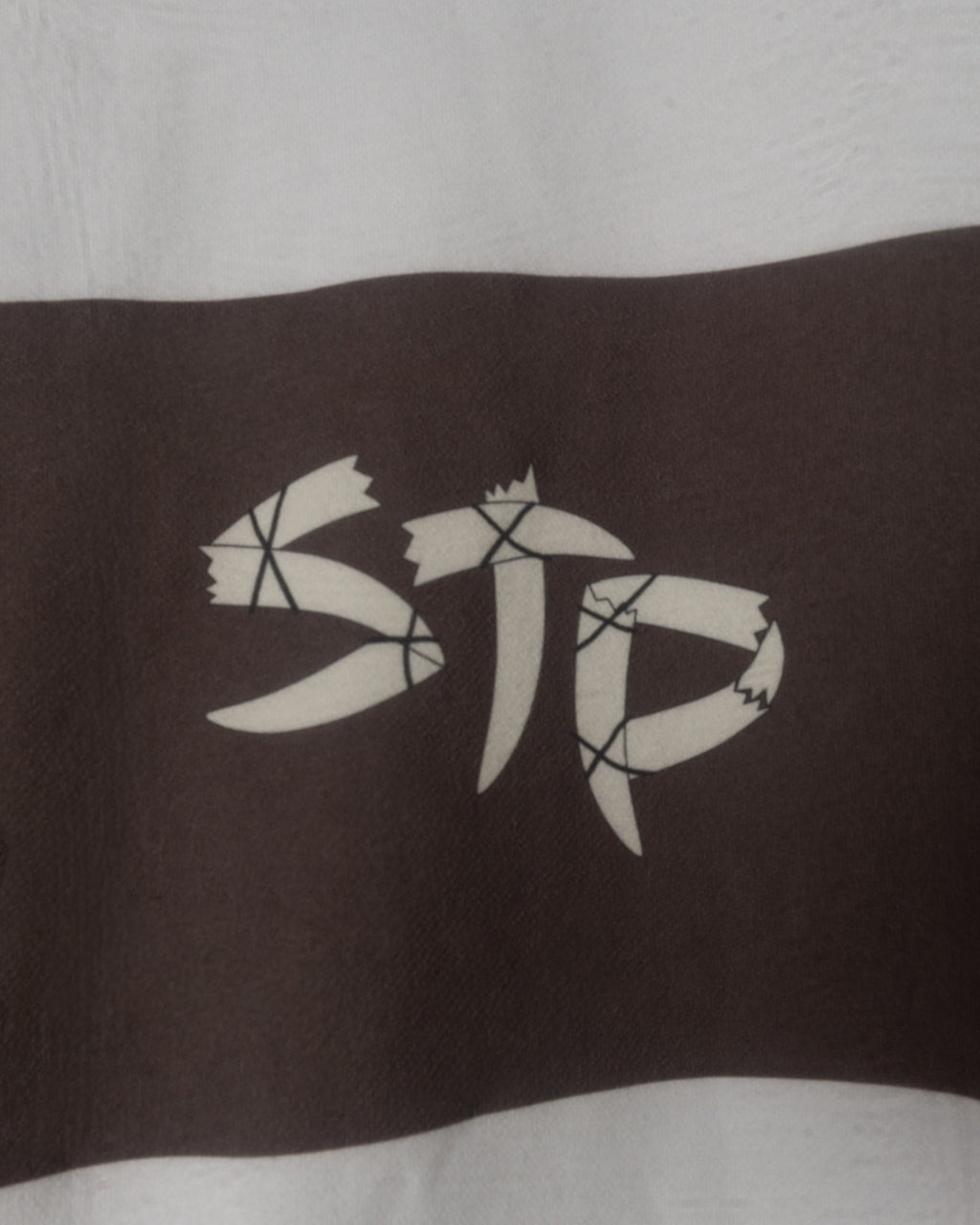 Black and white logo on a striped shirt