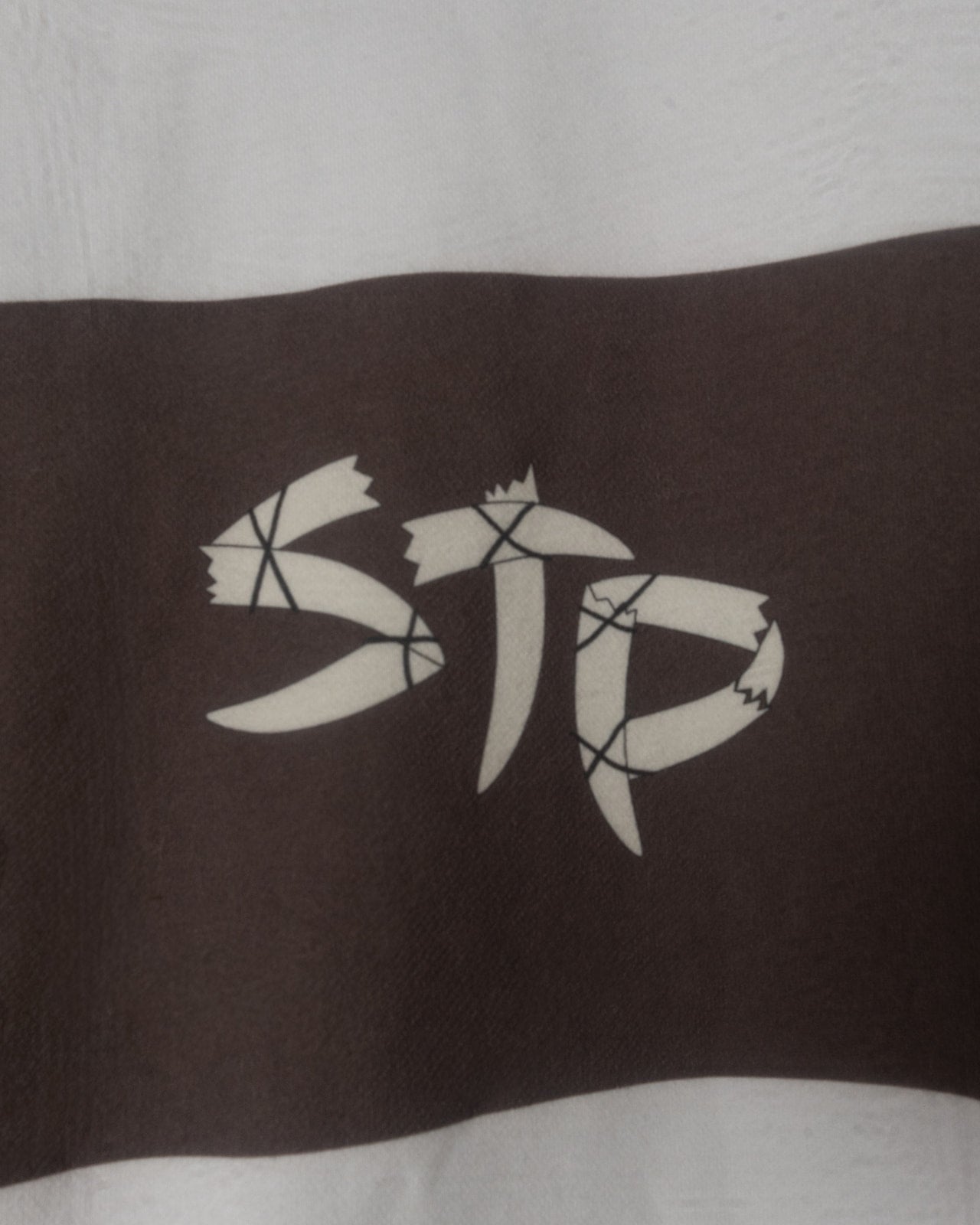 Black and white logo on a striped shirt