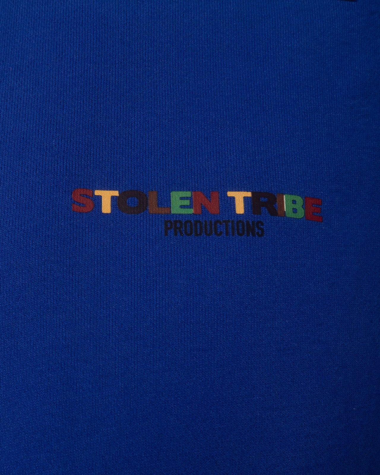 Colorful 'STOLEN TRIBE PRODUCTIONS' text on a blue background