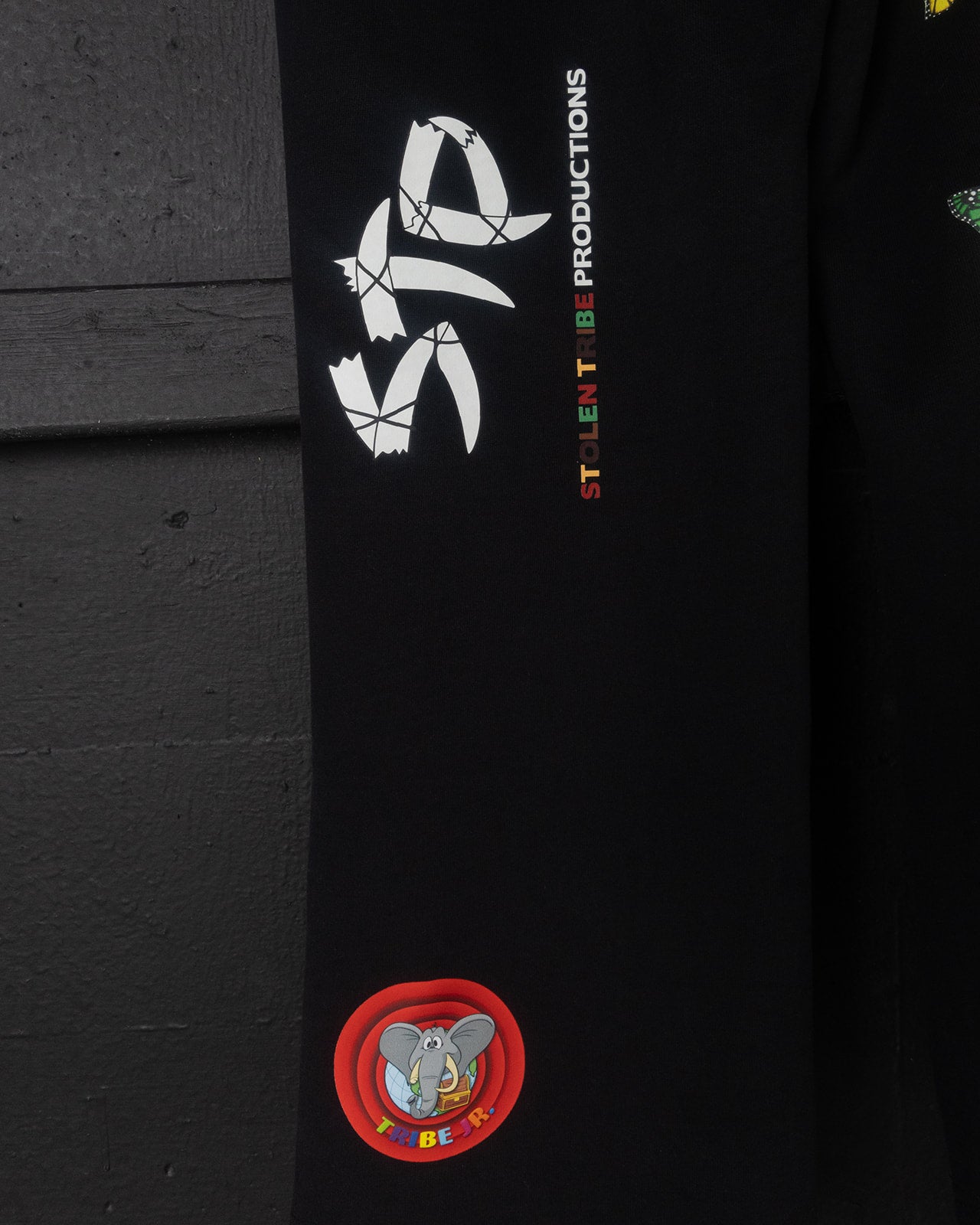 Black sweatpants with logos and text on a dark background