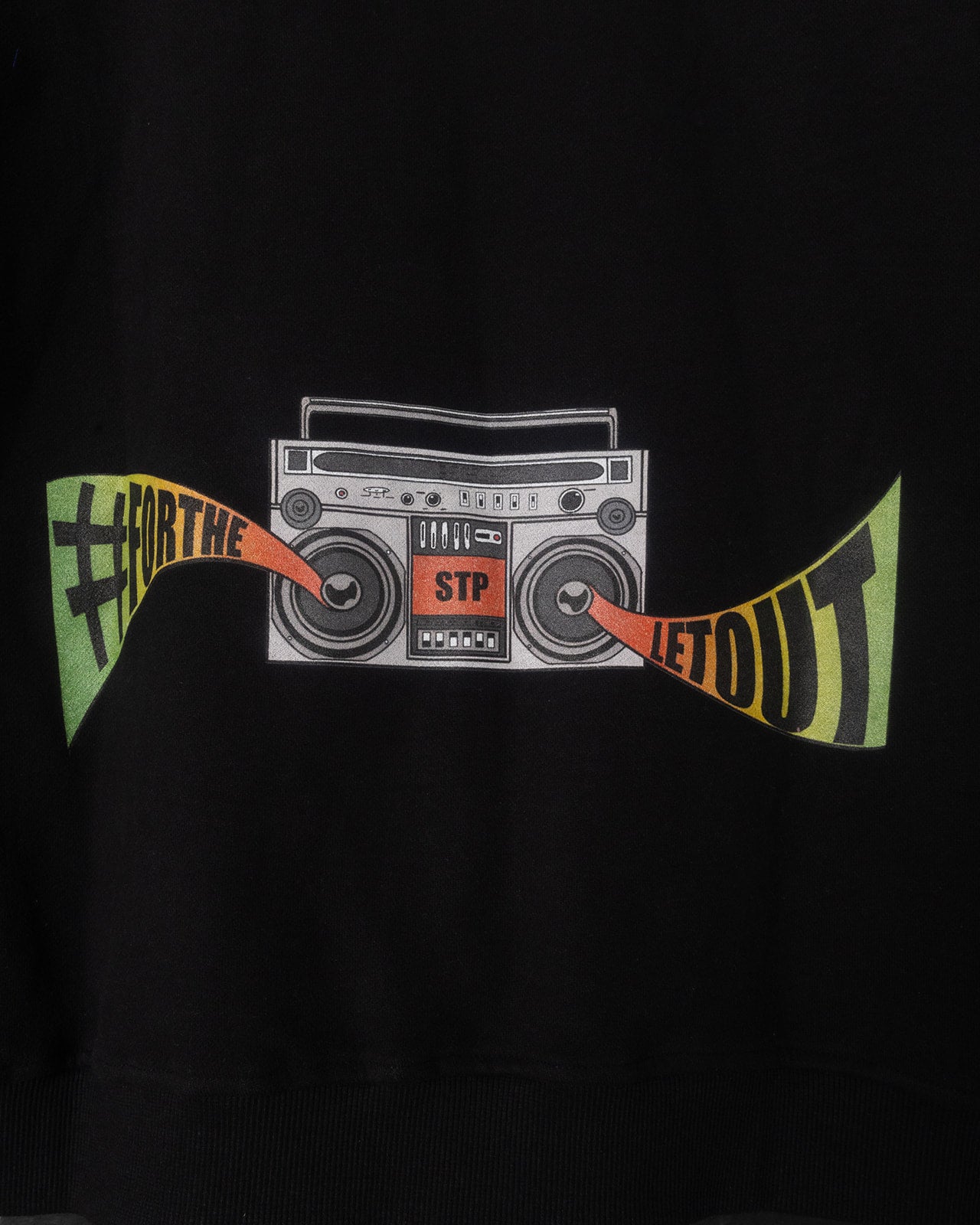 Black sweatshirt with a graphic of a boombox and text on a dark background