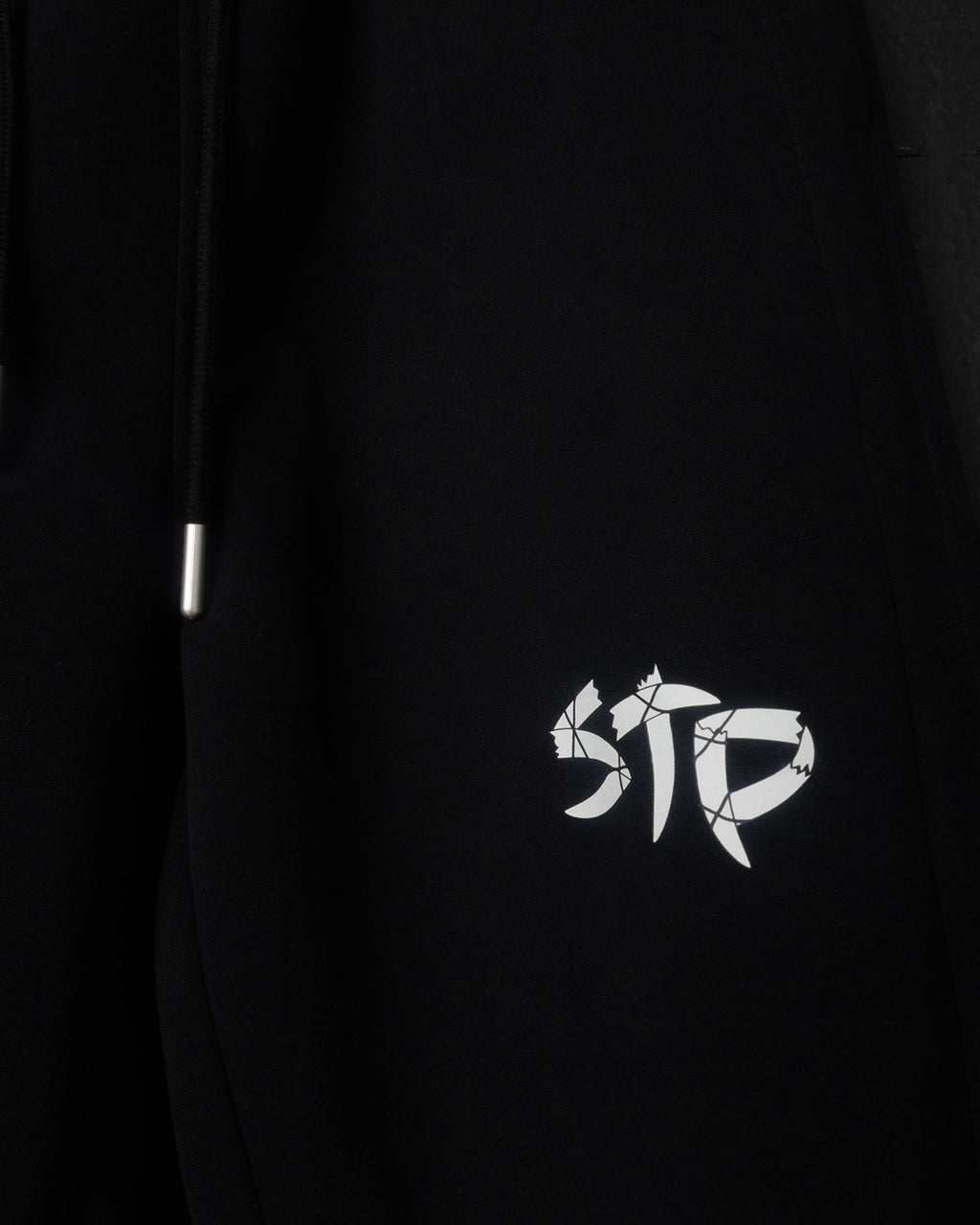 Black sweatpants with a white logo 