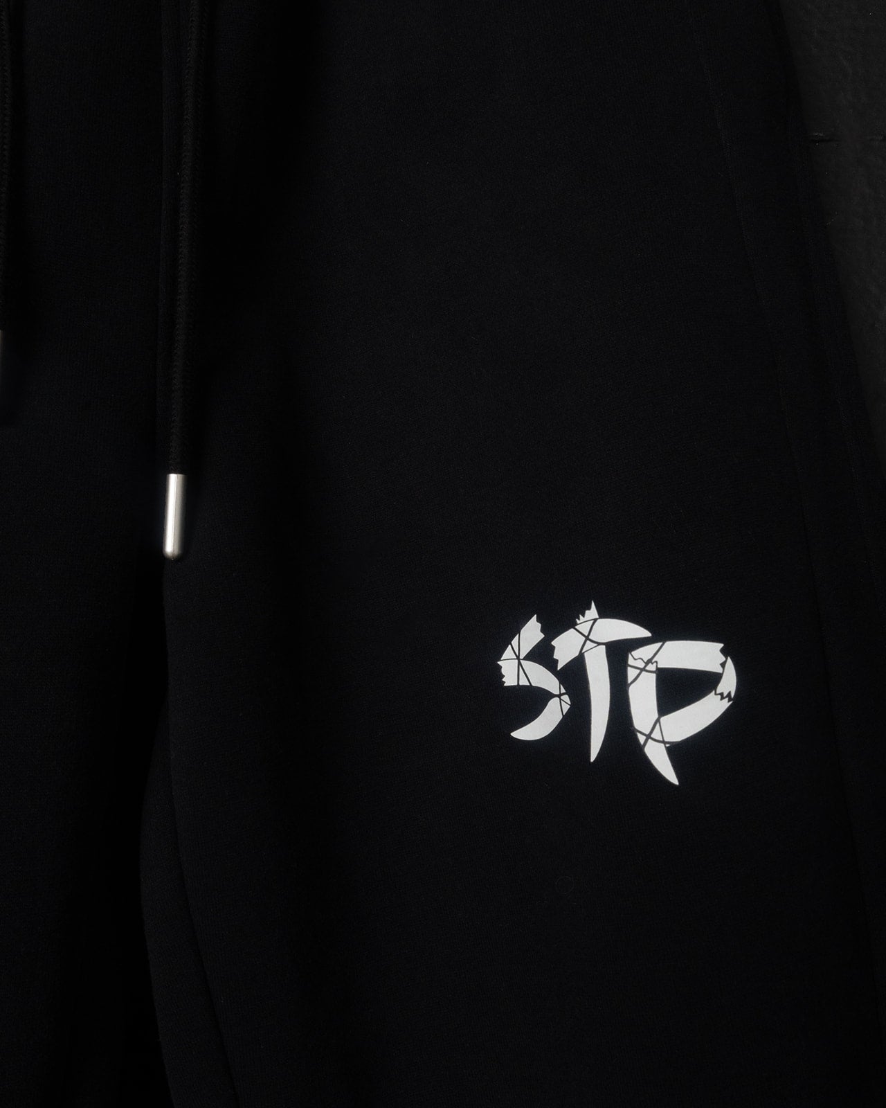 Black sweatpants with a white logo 