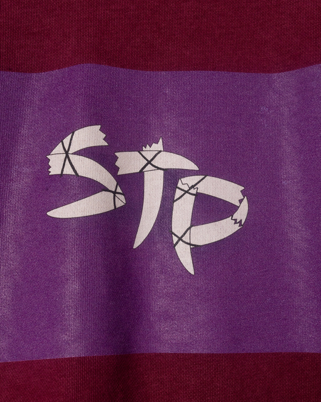 White logo on a purple and red striped background