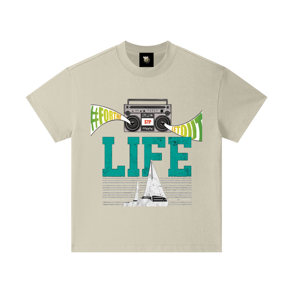 Beige t-shirt with graphic design featuring a cassette tape, sailboat, and text on a white background