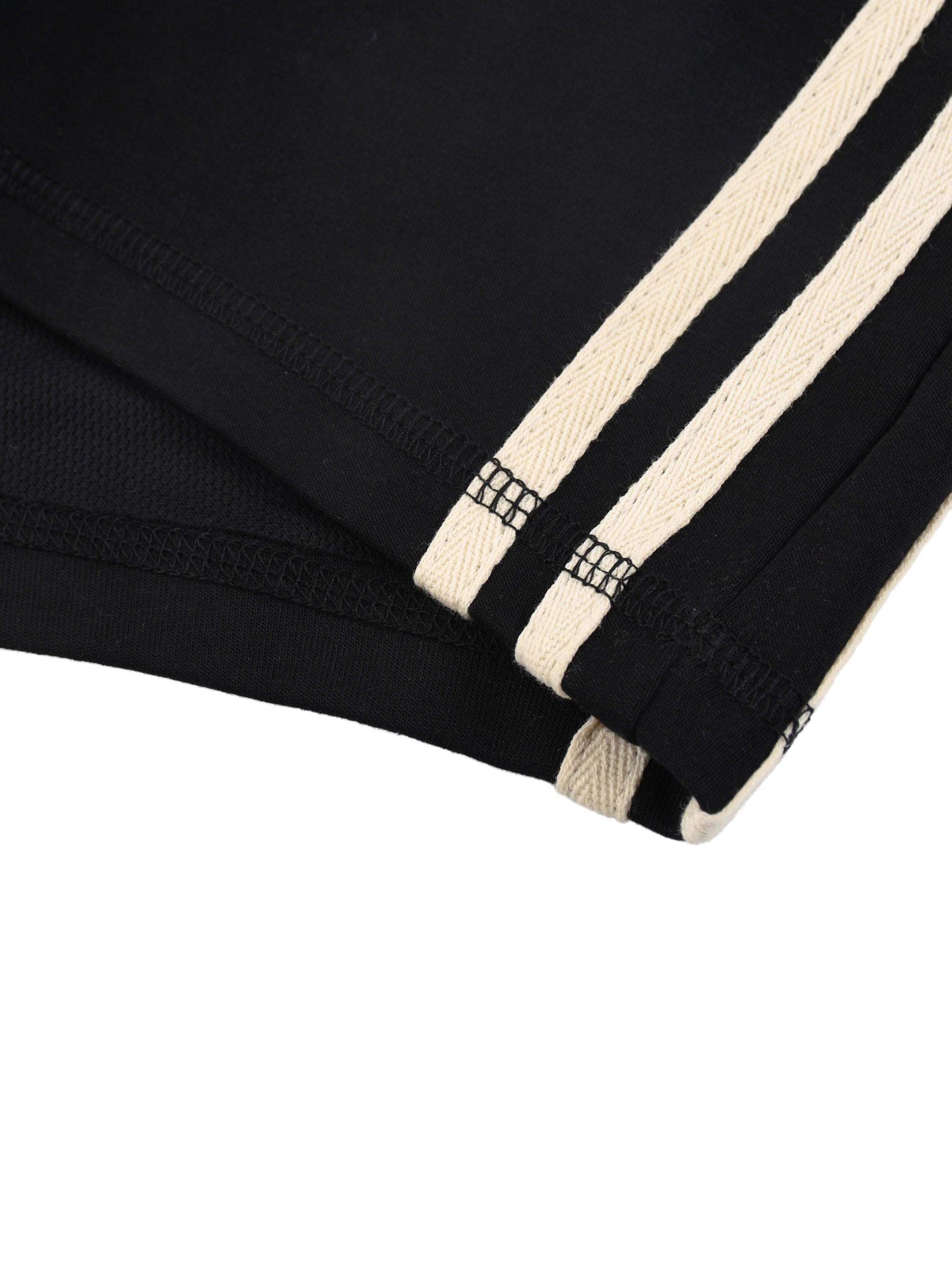 Close-up of a black garment with beige stripes on a white background