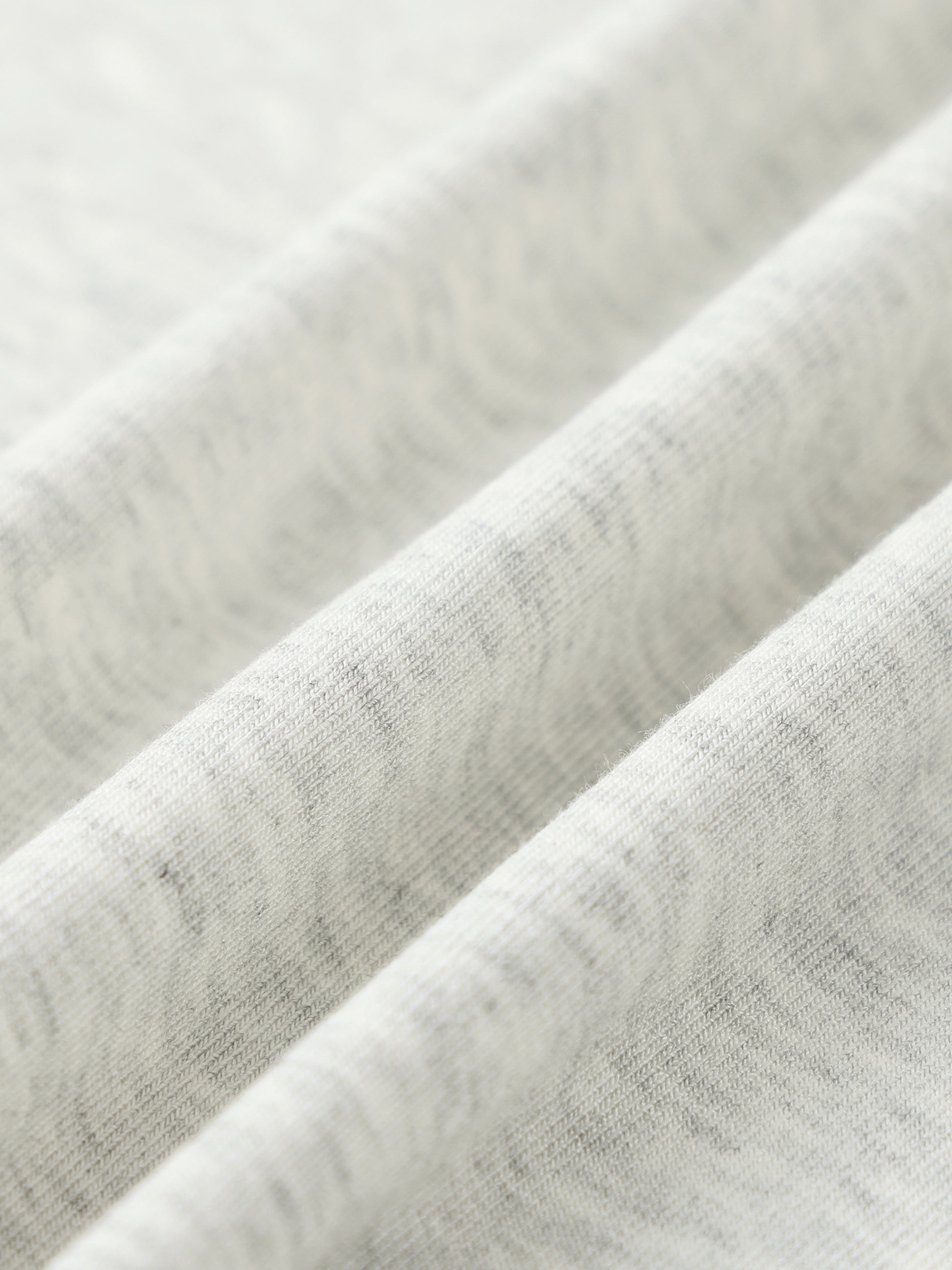 Close-up of textured gray fabric with a subtle pattern