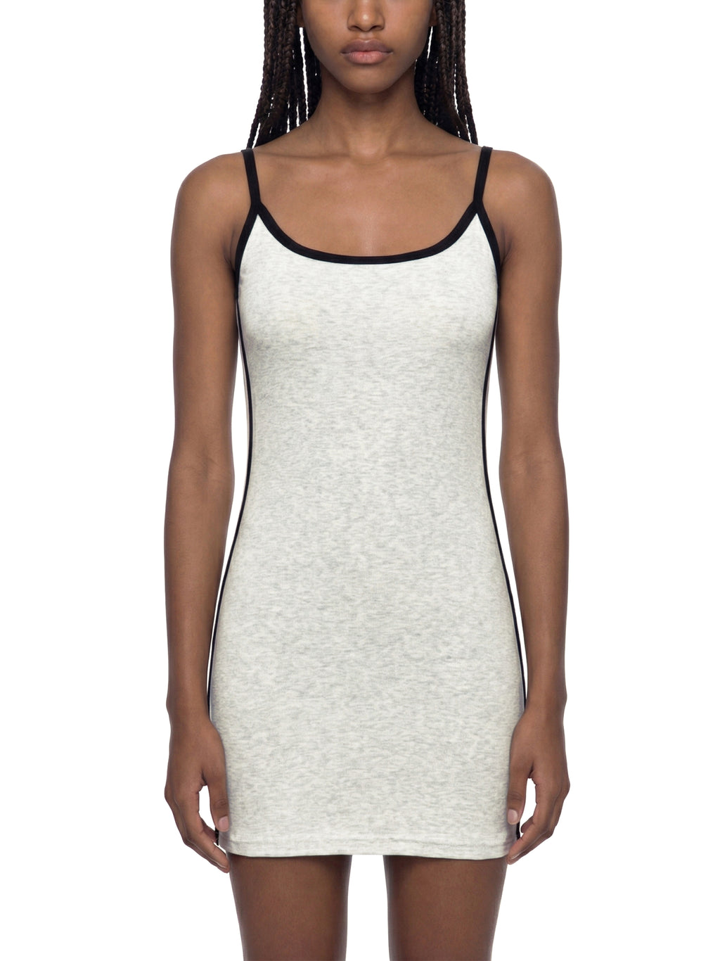 Woman wearing a white tank dress with black straps on a white background