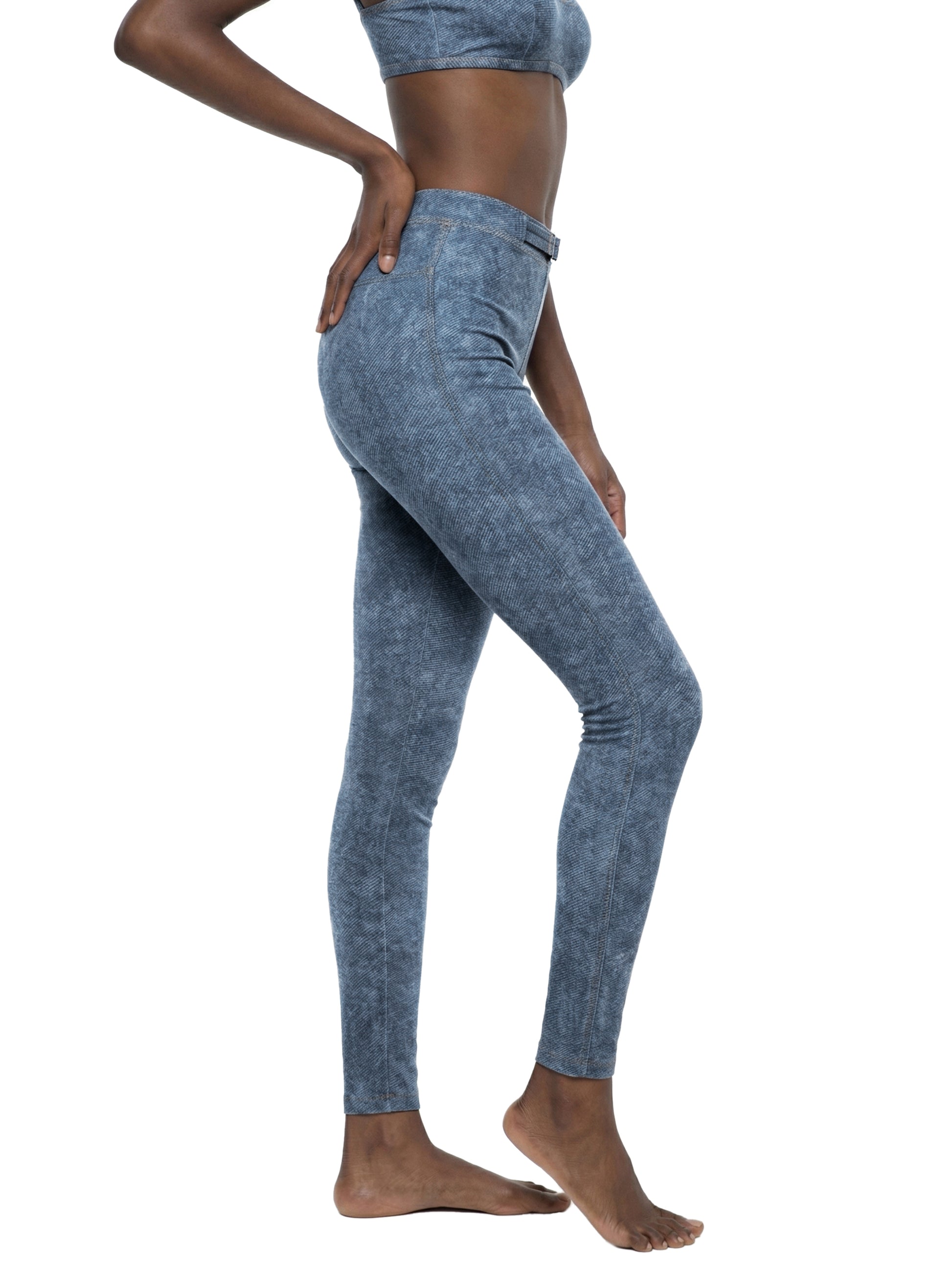 Person wearing blue leggings on a white background