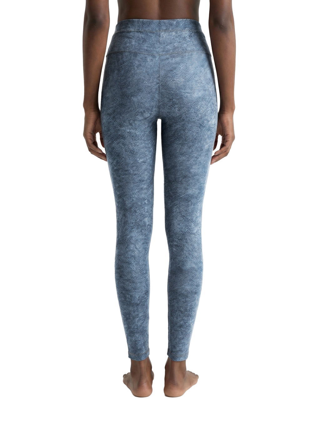 Blue leggings worn by a person on a white background