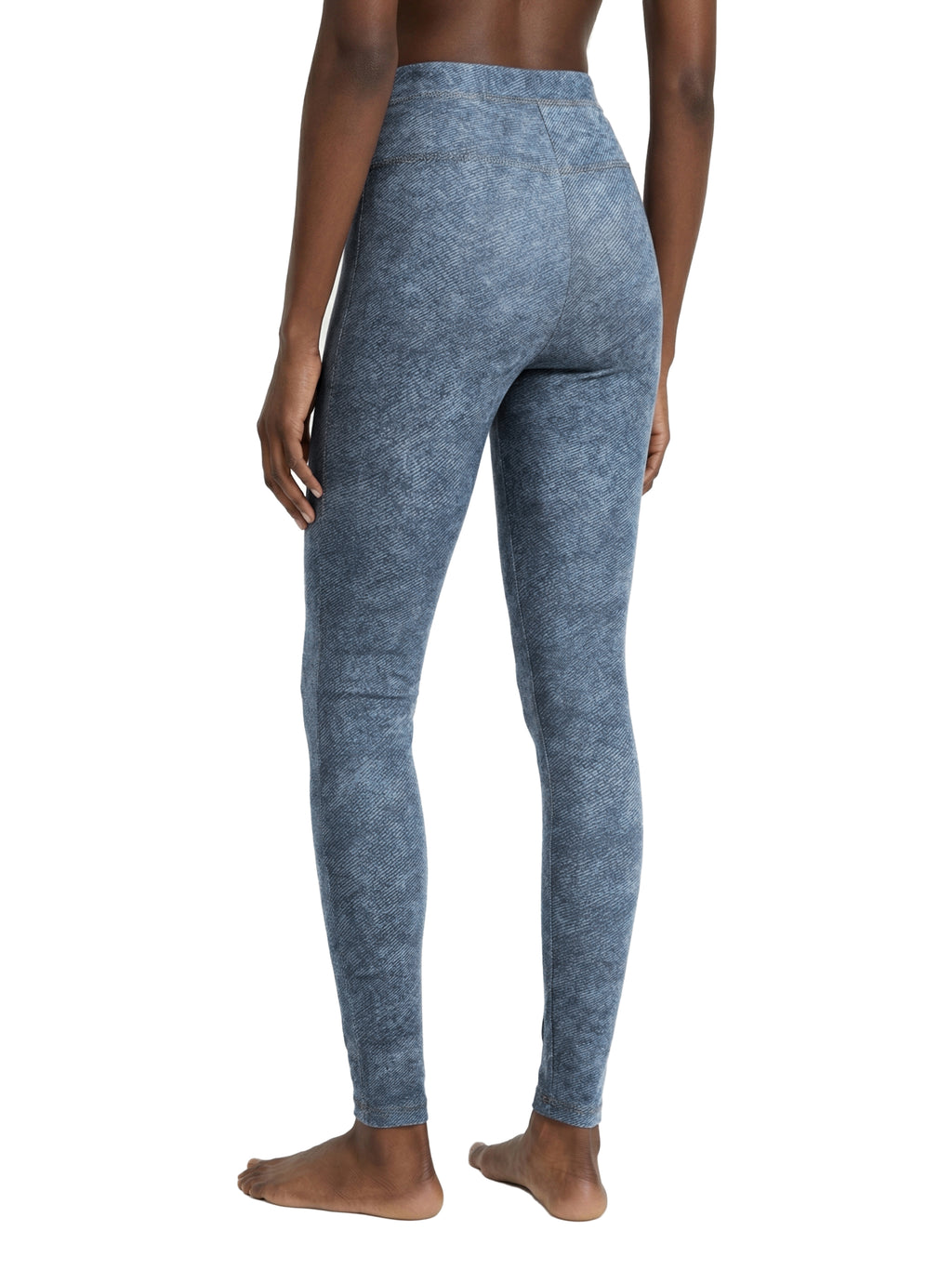 Blue leggings worn by a person on a white background