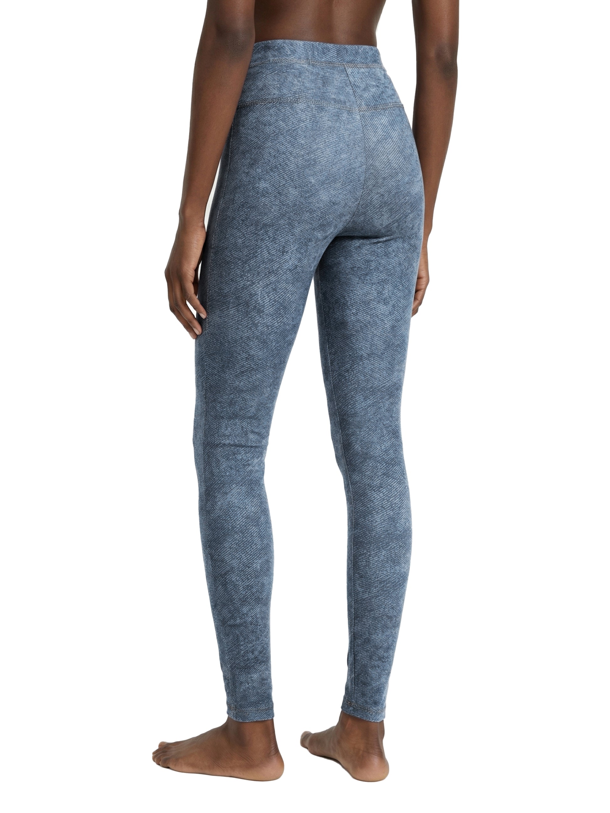 Blue leggings worn by a person on a white background
