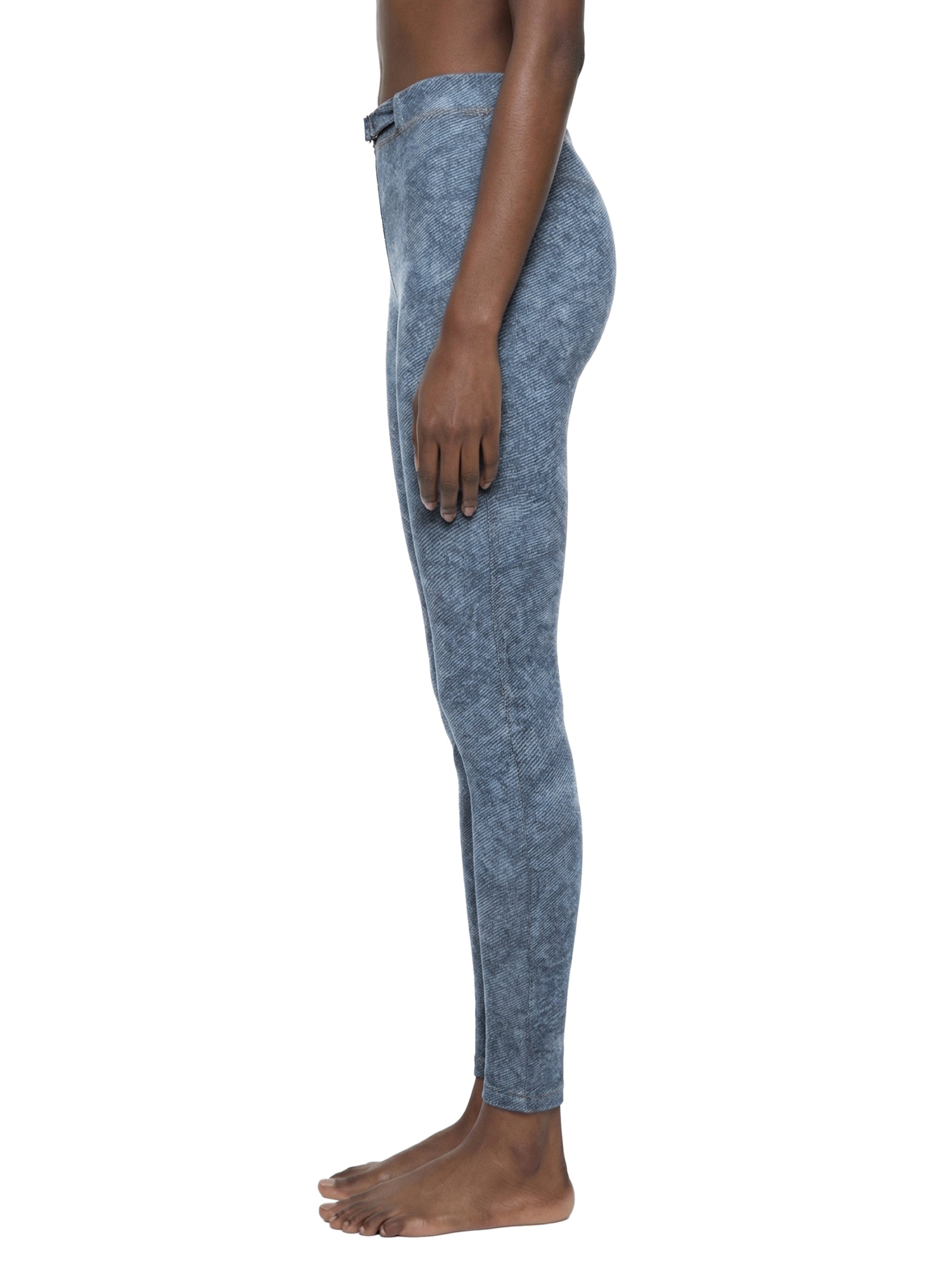 Person wearing blue leggings on a white background