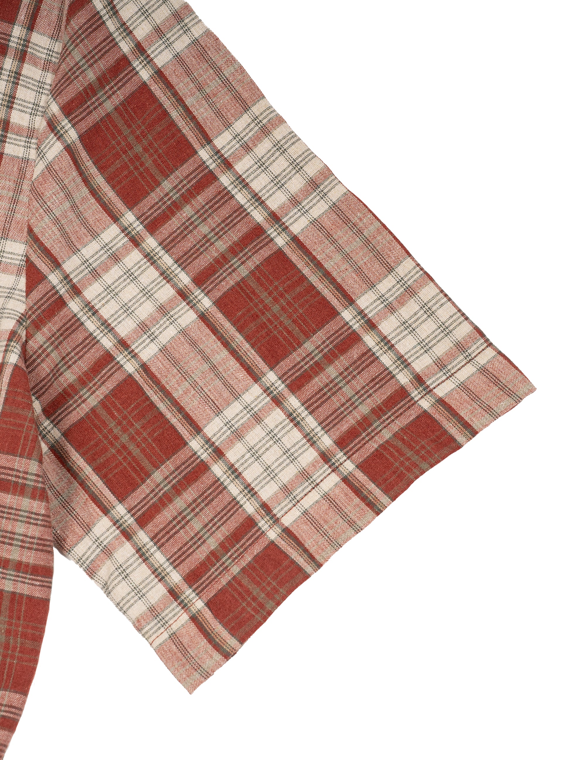 Red and beige plaid fabric on a white background