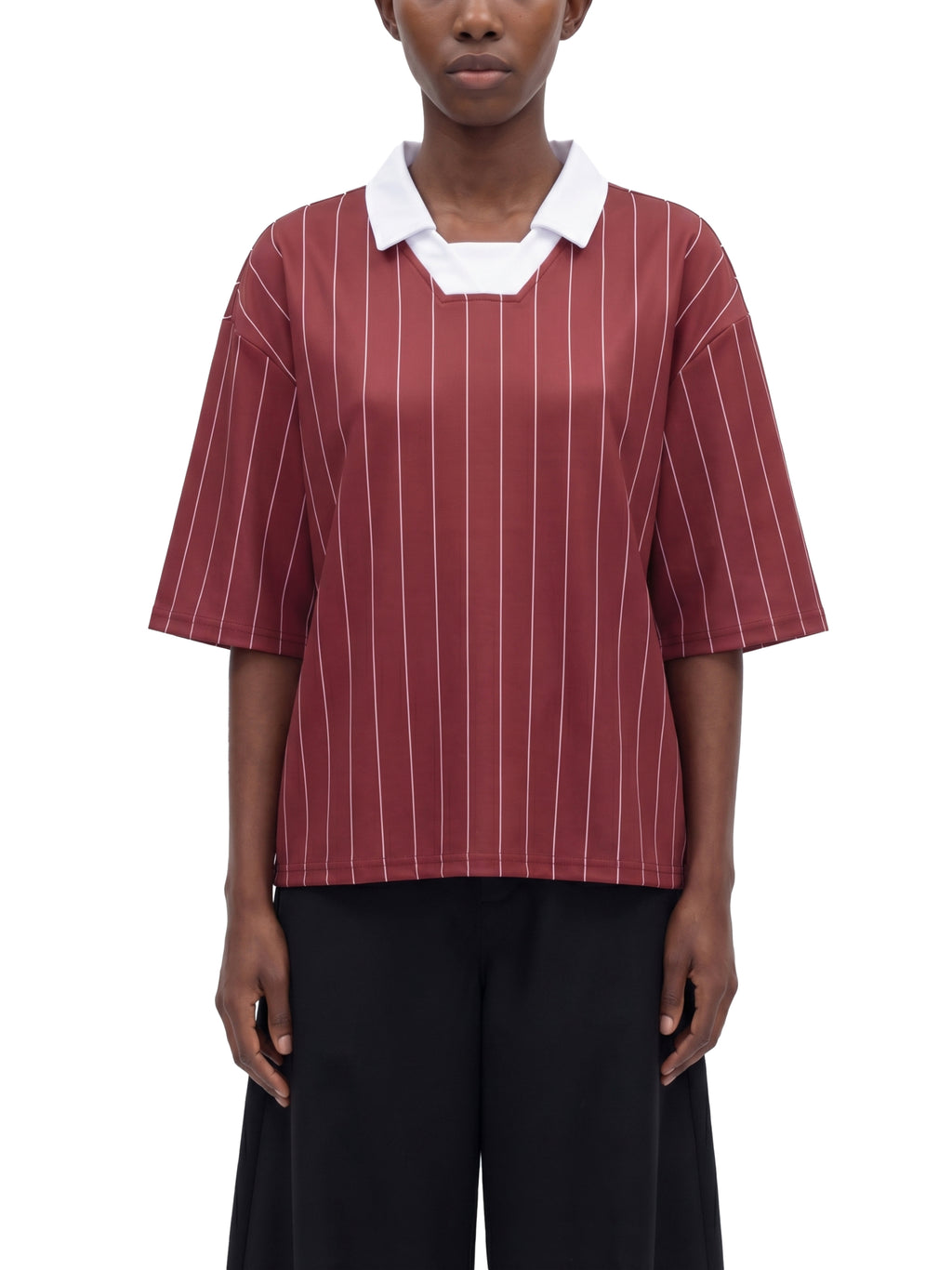 Person wearing a maroon and white striped shirt with a white collar on a white background