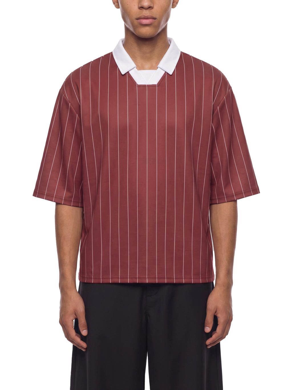 Person wearing a maroon and white striped shirt with a white collar on a white background