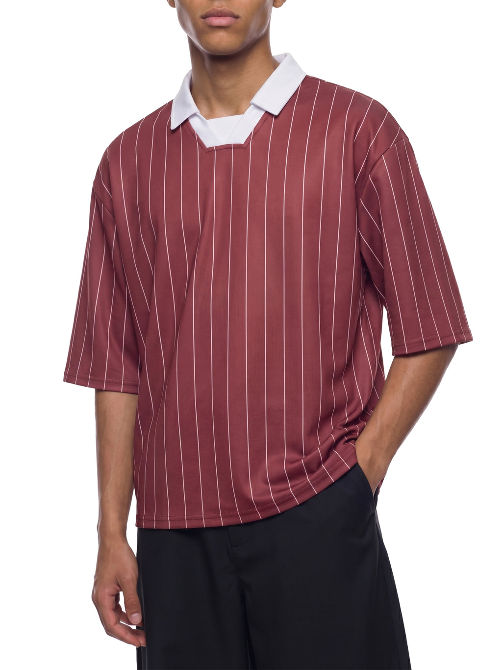 Person wearing a maroon and white striped shirt with a white collar on a white background