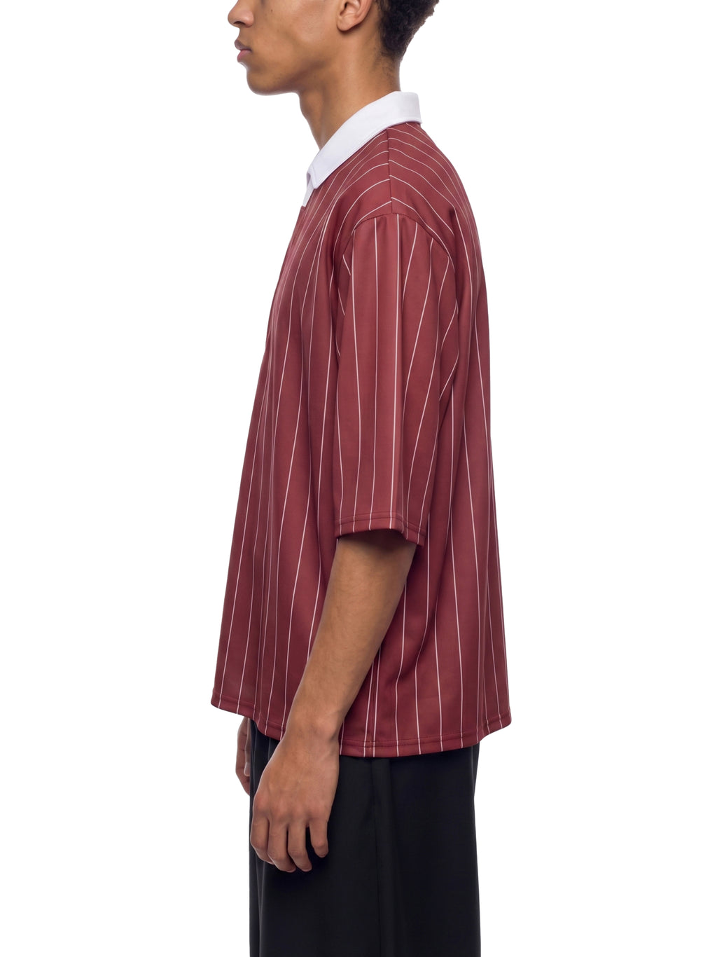 Person wearing a maroon and white striped shirt on a white background