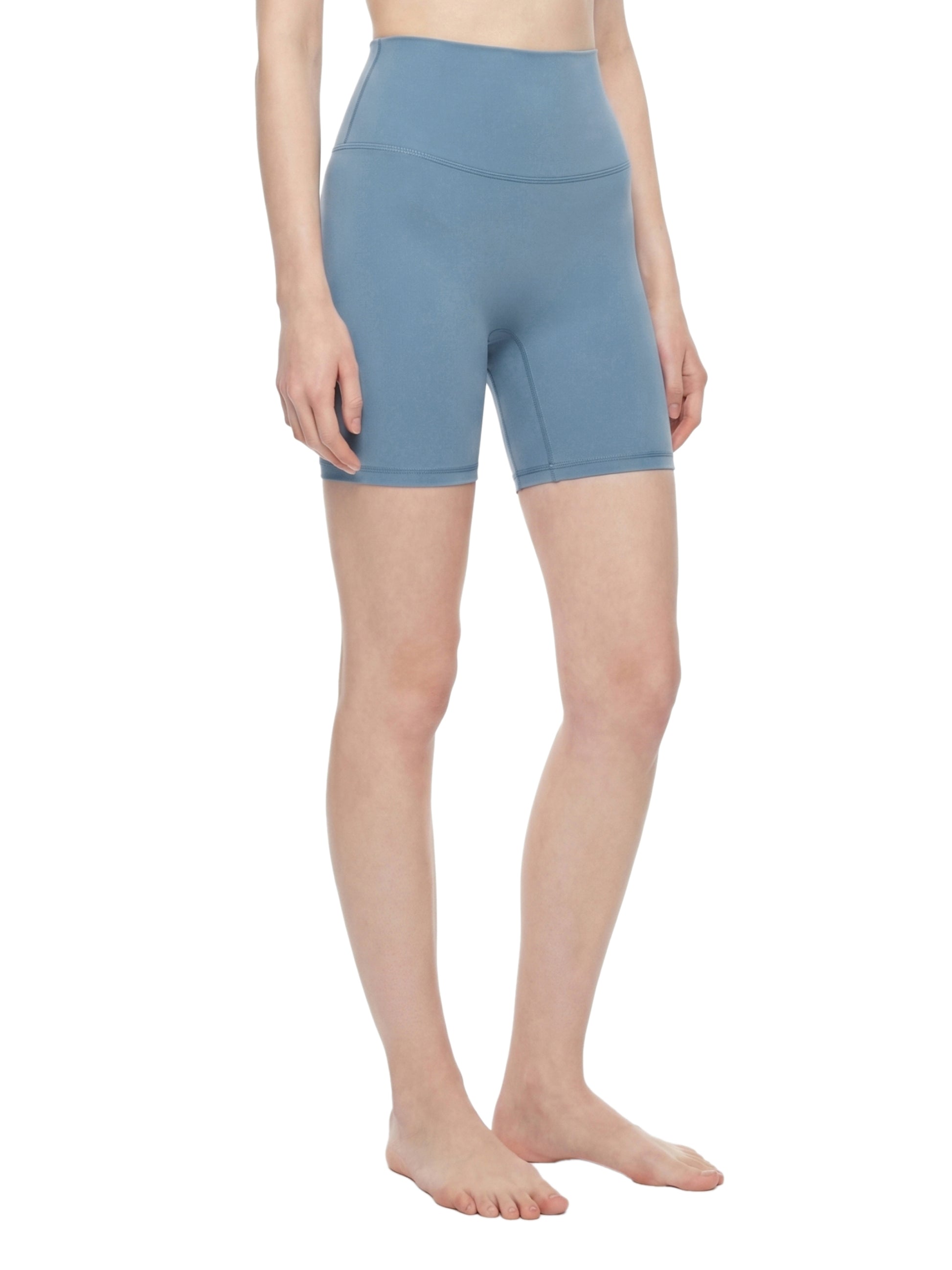Person wearing light blue shorts on a white background
