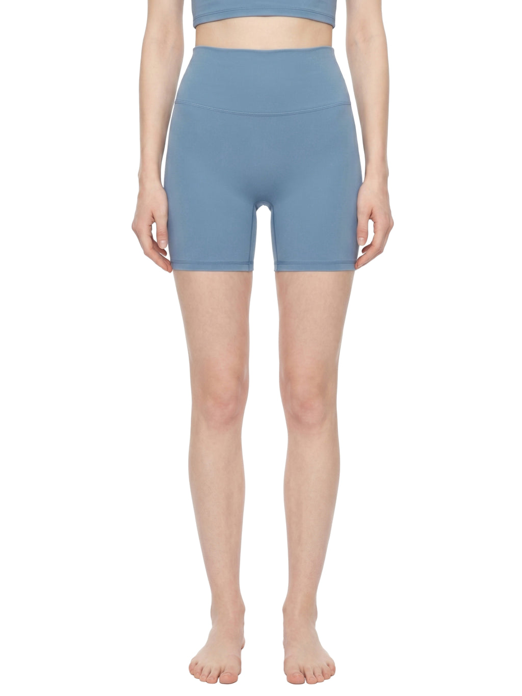Person wearing blue athletic shorts on a white background