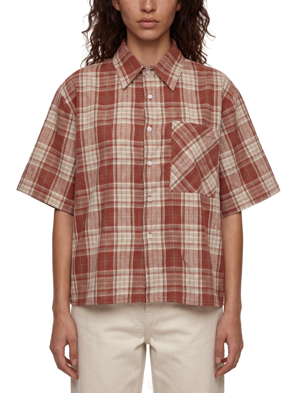 Person wearing a plaid shirt with a white background