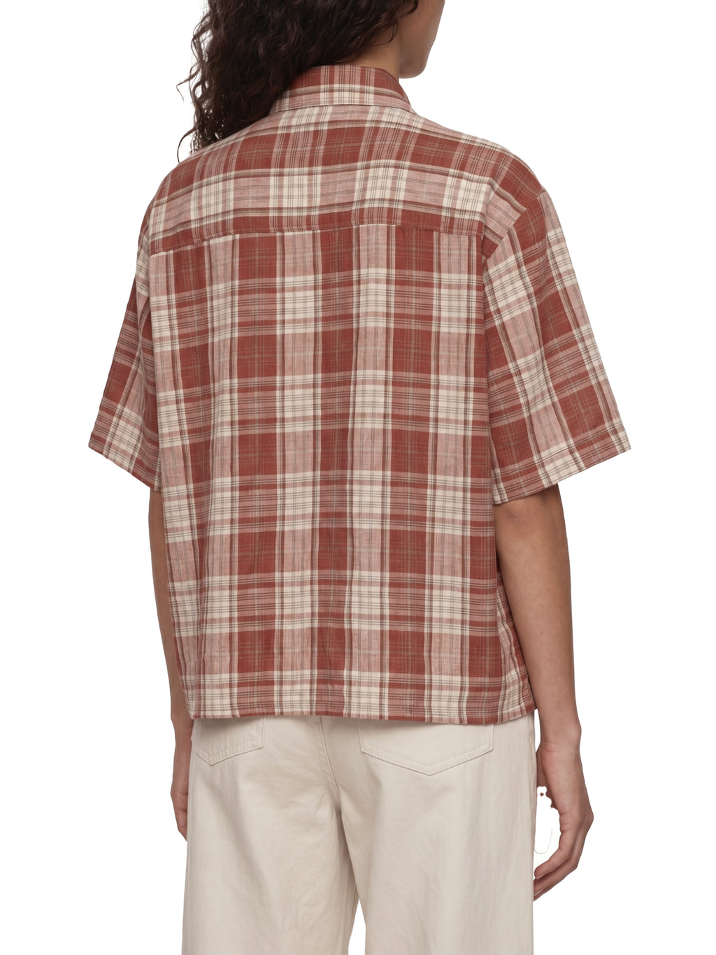Person wearing a plaid shirt with short sleeves on a white background