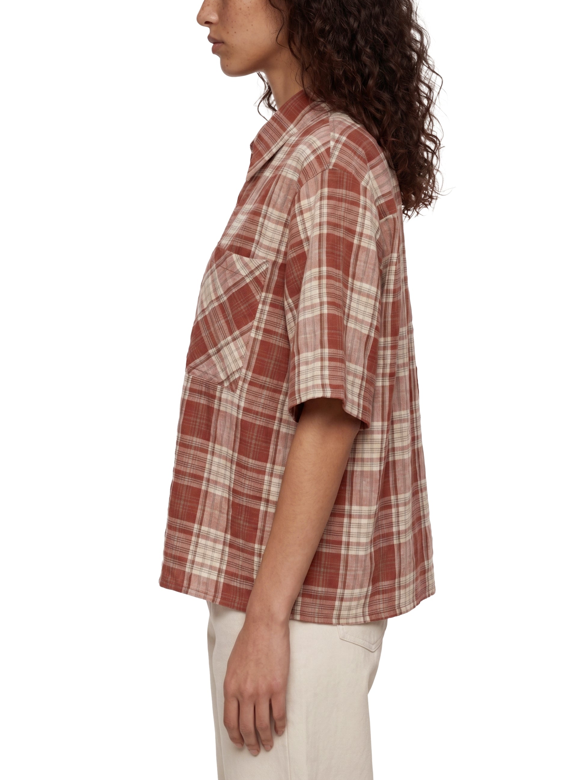 Person wearing a plaid shirt on a white background