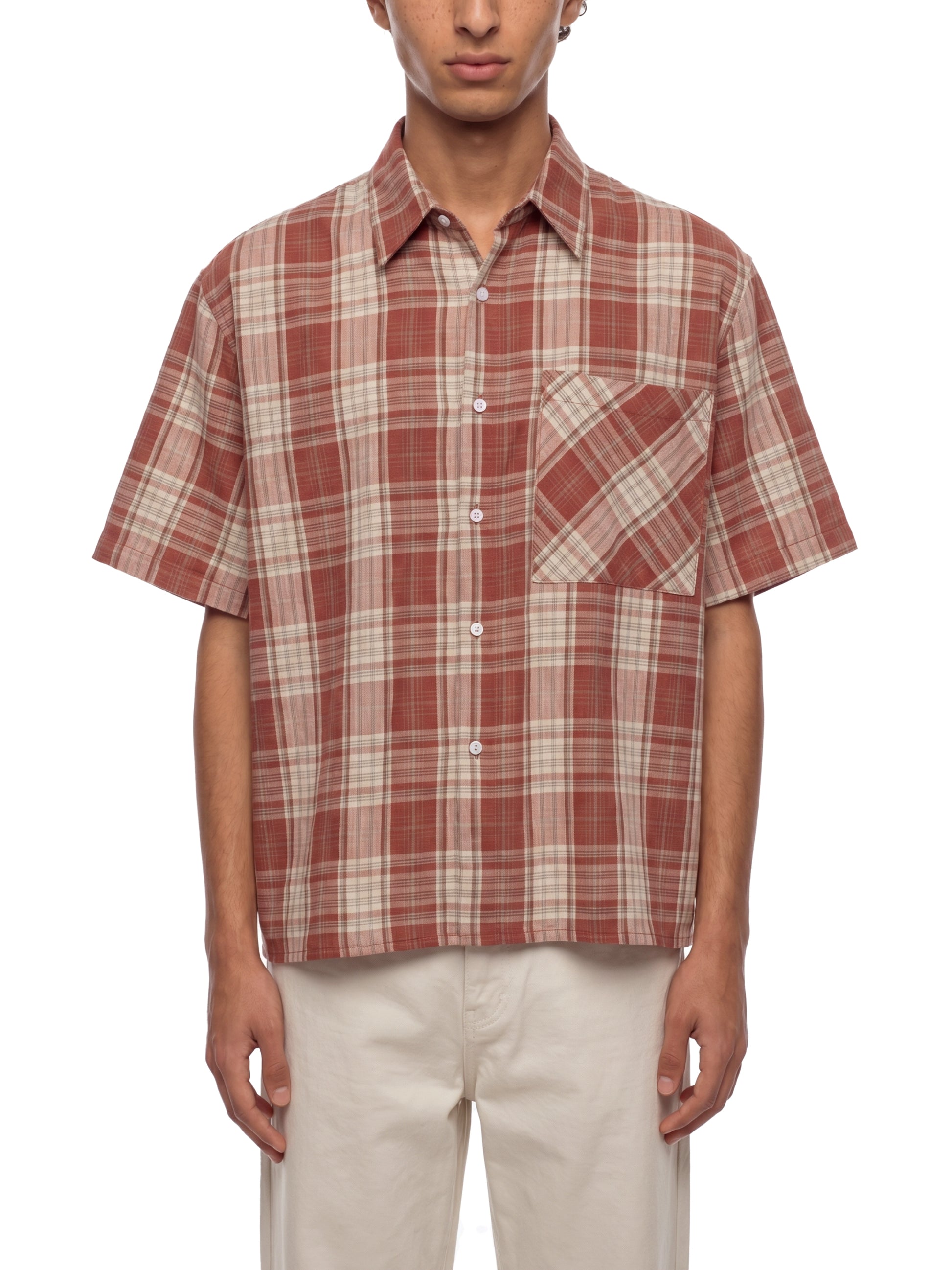 Person wearing a plaid short-sleeve shirt on a white background