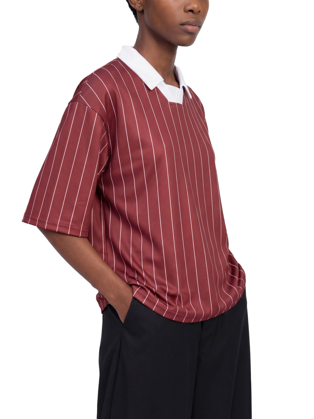 Person wearing a red and white striped shirt with a white collar on a white background