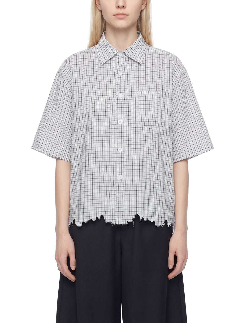 Person wearing a checkered shirt with a white background