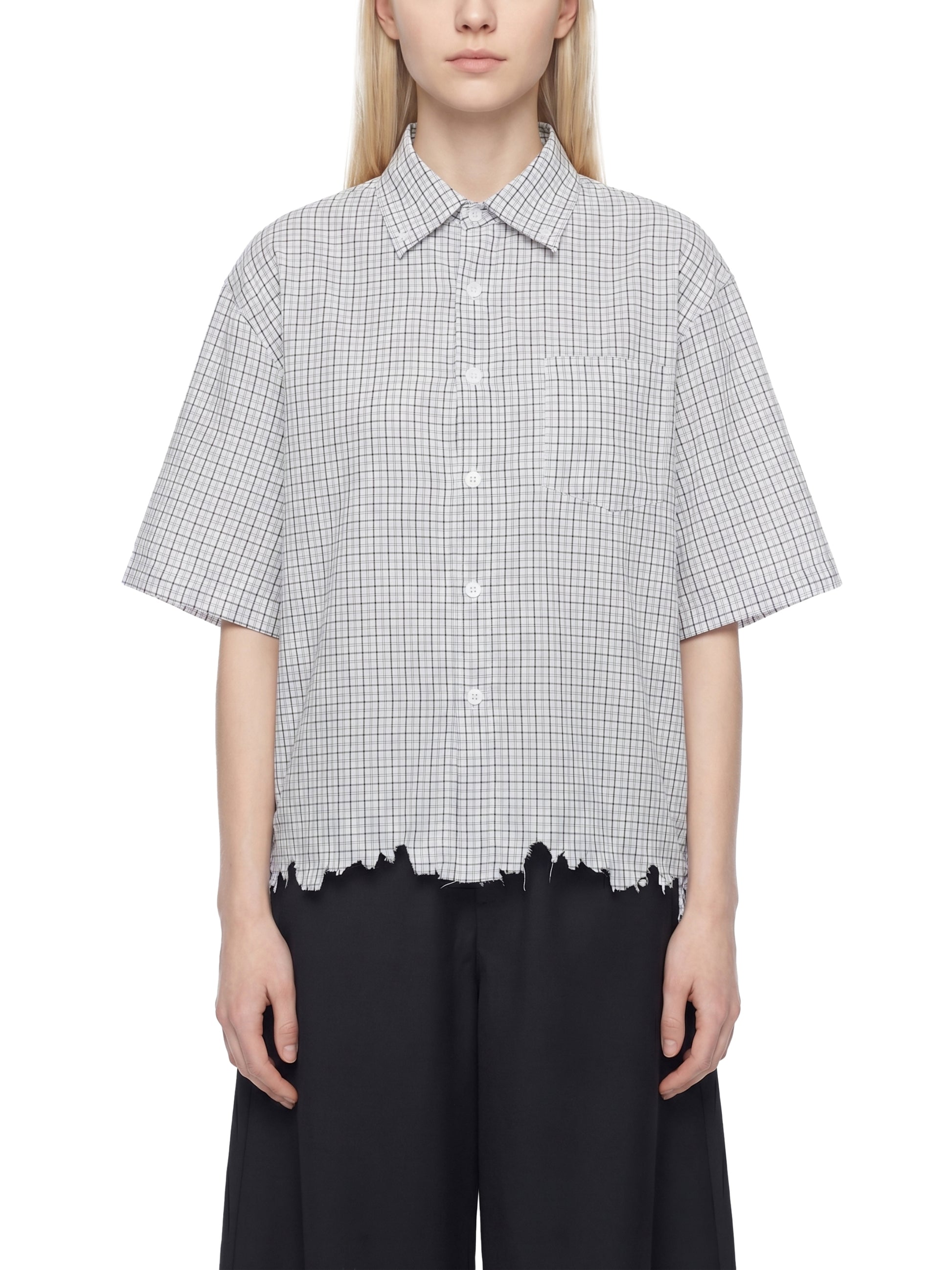 Person wearing a checkered shirt with a white background