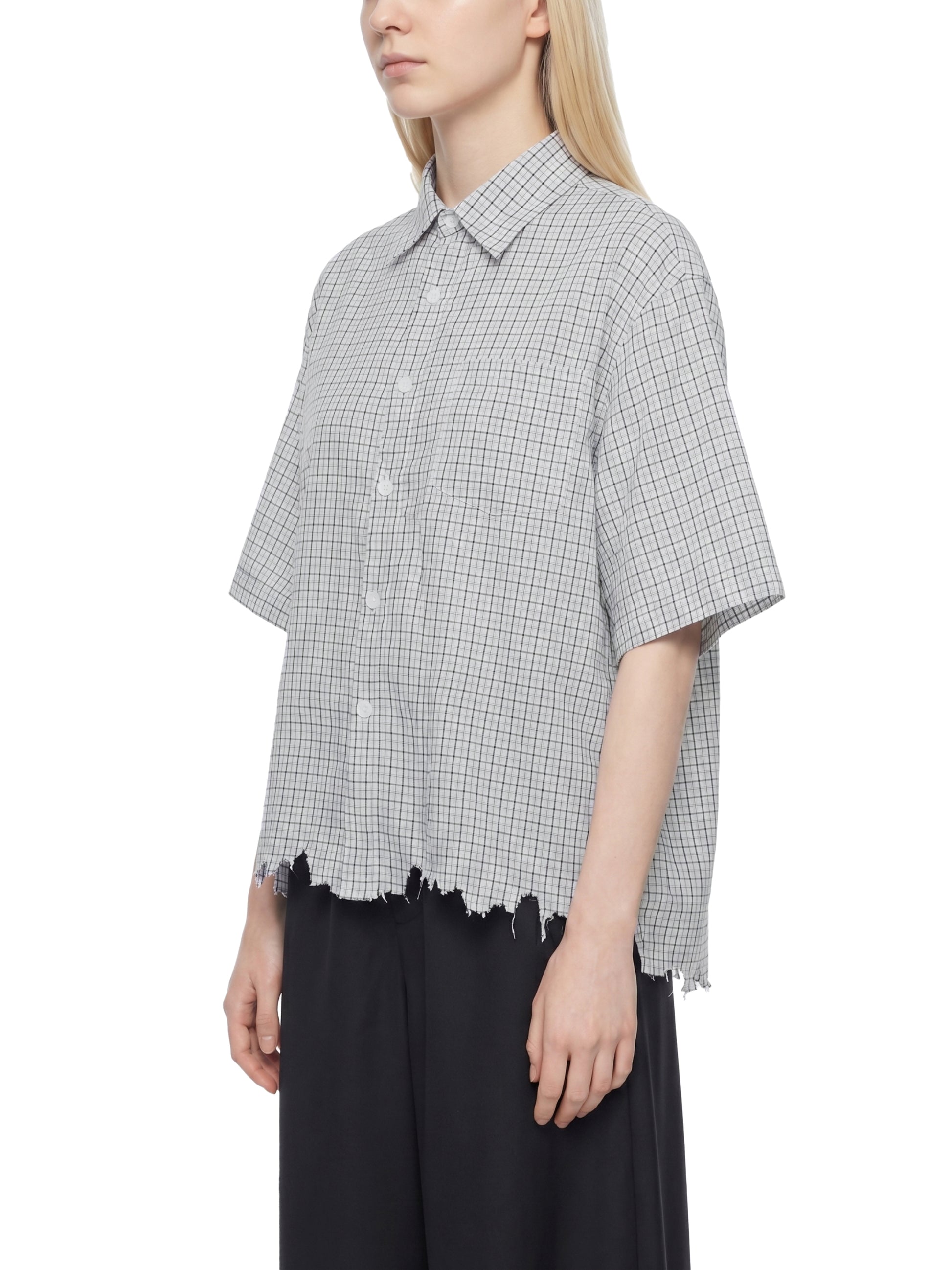 Person wearing a checkered shirt with a white background