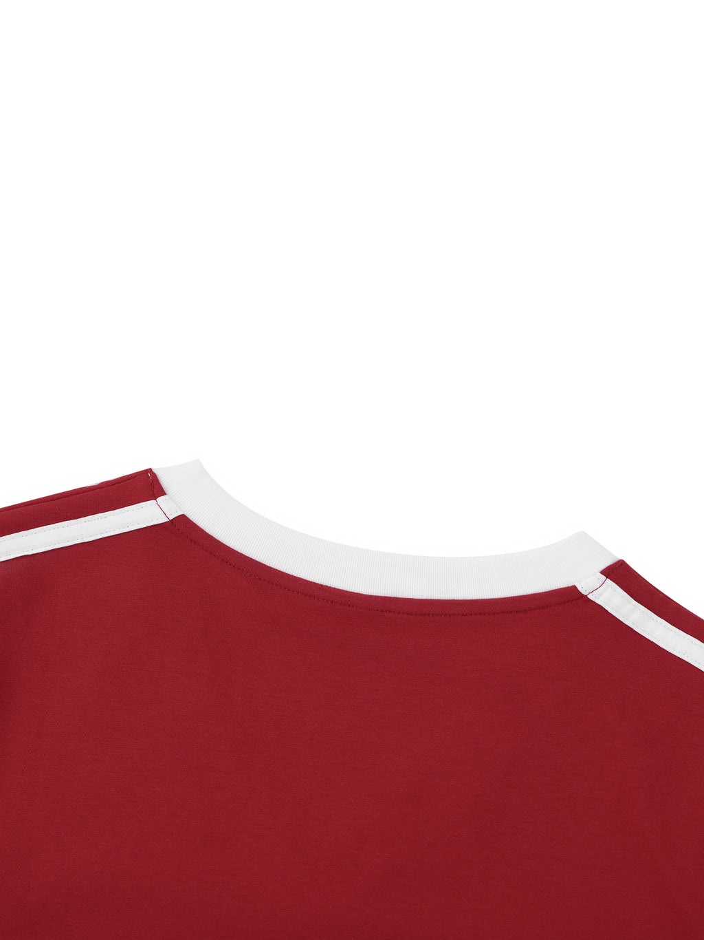 Close-up of a red shirt with white trim on a white background