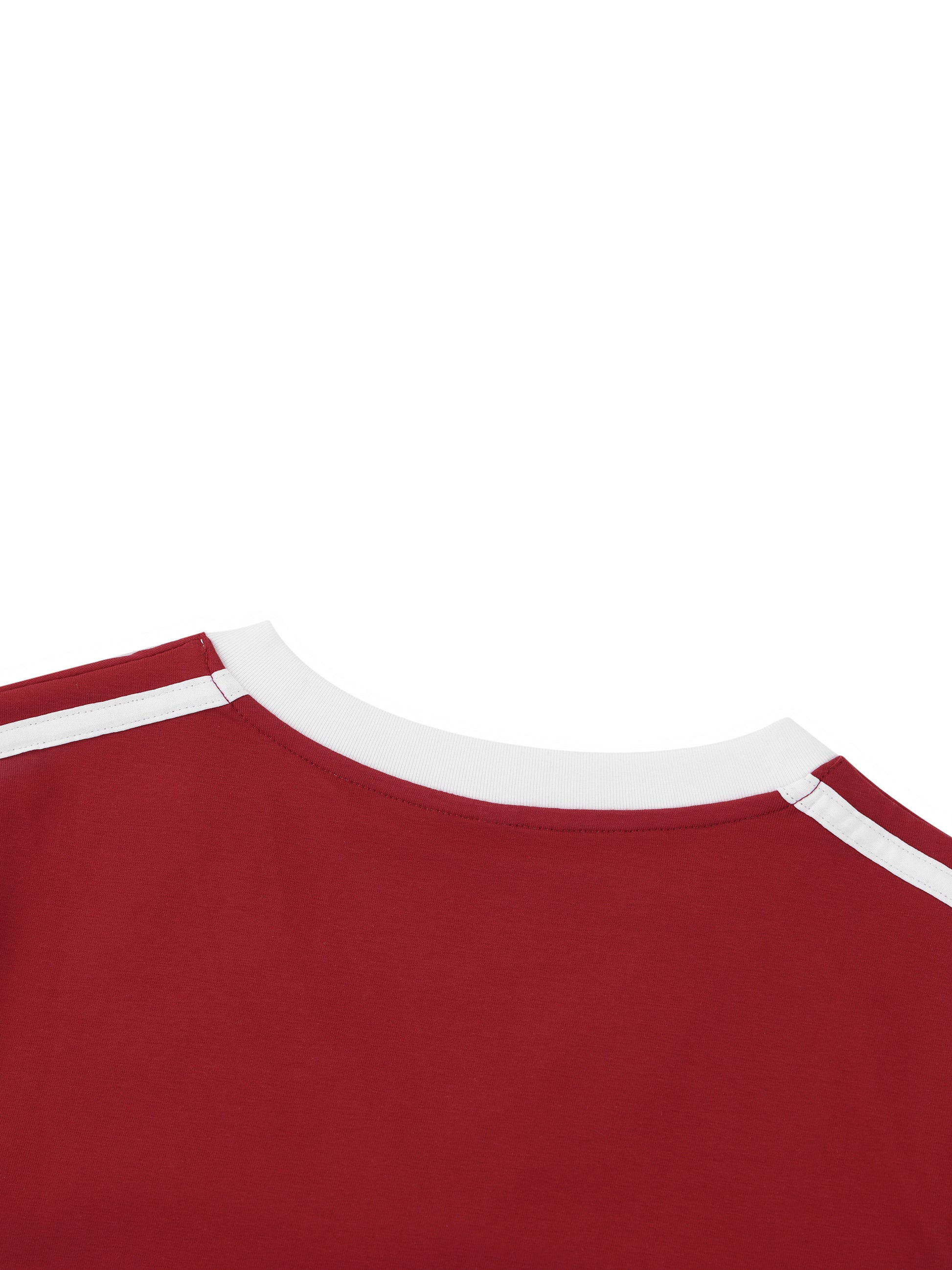 Close-up of a red shirt with white trim on a white background