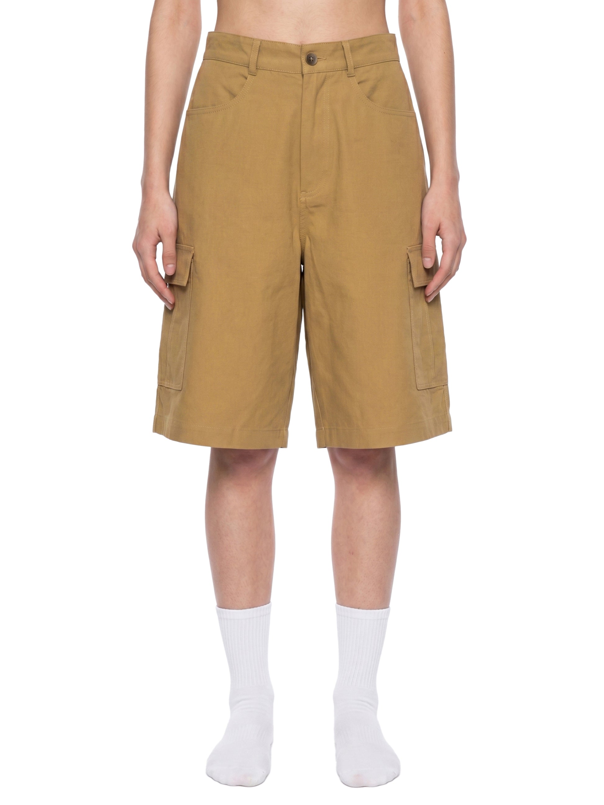 Person wearing tan cargo shorts on a white background